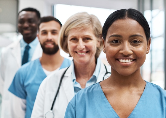 Portrait of a group of medical practitioners standing together in a hospital.